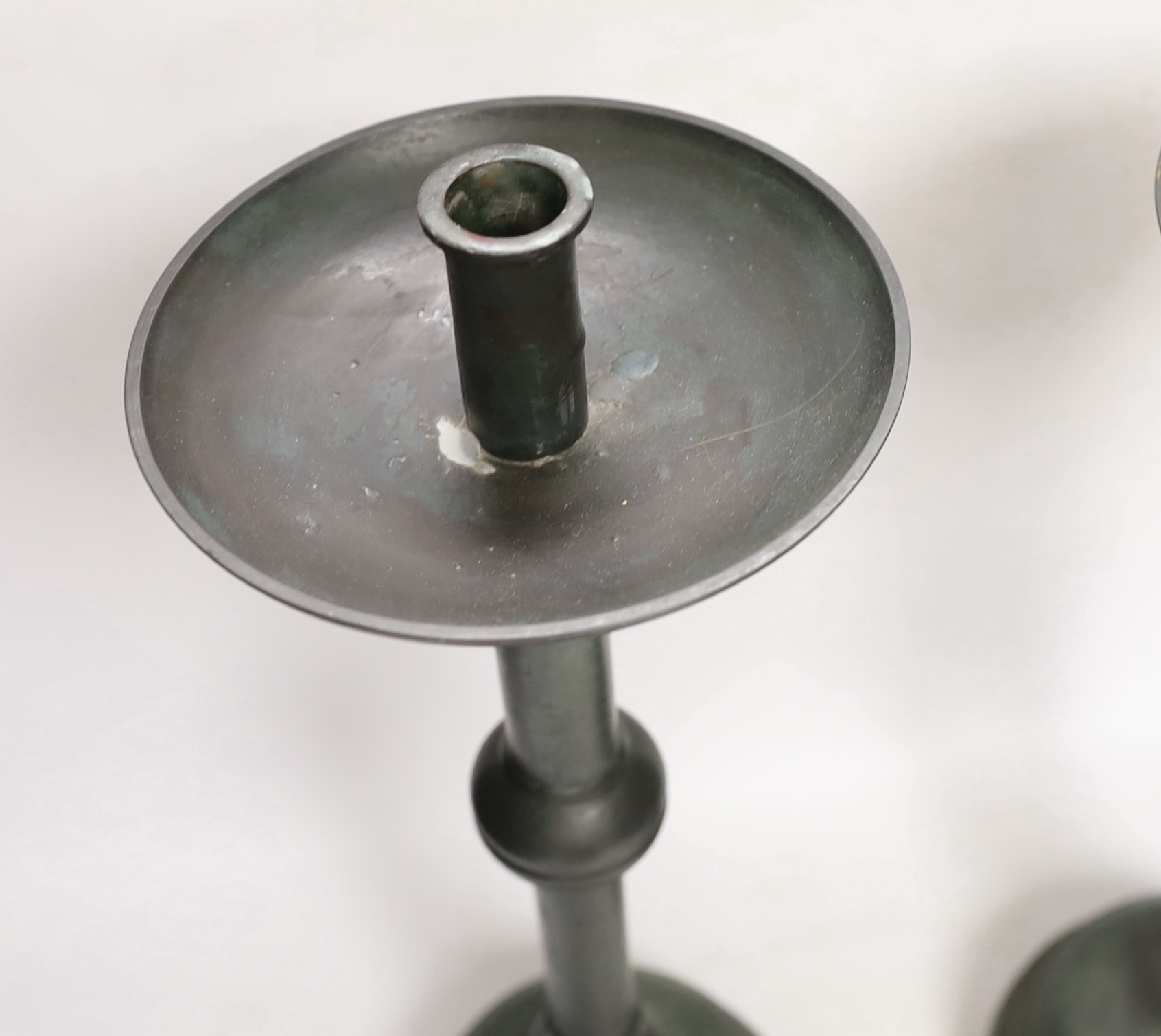 A pair of bronze candlesticks, 45.5cm, and a pair of stags, all with green patina